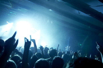 Fototapeta na wymiar People having fun at rock concert in a music club