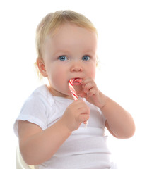 Infant child baby boy toddler eating christmas candy cane