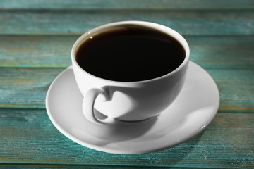 Cup of coffee on wooden table