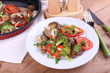 Braised wild mushrooms with vegetables and spices in pan and