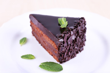 Delicious chocolate cake on plate on bright background