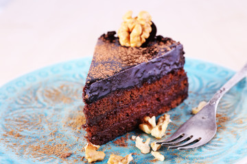 Delicious chocolate cake on plate on bright background