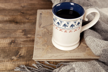 Cup of tea with book on table close-up