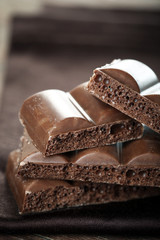 Tasty porous chocolate on wooden table