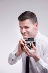 Fototapeta premium photographer with an oldstyle analogue photocamera shooting phot