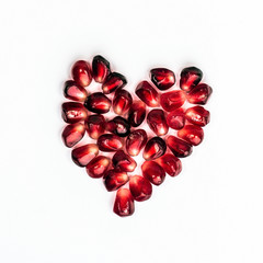 Heart of pomegranate seeds isolated on white background