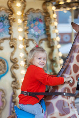  girl riding on  carousel