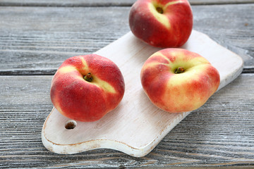 flat peach on cutting board