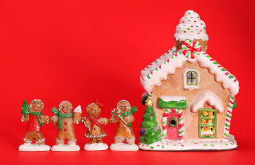 Gingerbread house and people over red background