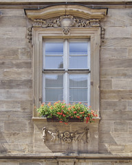 Fototapeta na wymiar vintage home window with flowers, Bamberg, Germany