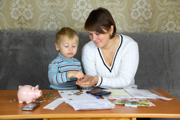 boy with his mother engaged in household finances - 74064959