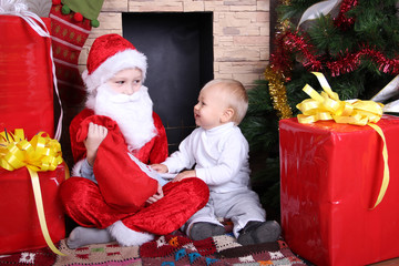 Fototapeta na wymiar little boy and Santa Claus with gifts