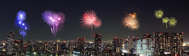 Fireworks celebrating over Tokyo cityscape at night