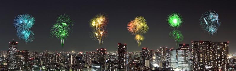 Fireworks celebrating over Tokyo cityscape at night
