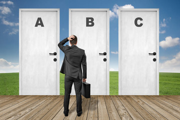 man standing in front of the door A B C