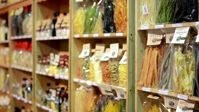 colourful pasta (olive oil, flour etc.) in bags in shelf - shop