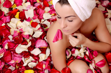 Obraz na płótnie Canvas Beautiful female in bath with rose petal. Body care.