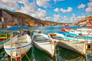 Fototapeta na wymiar Boats in Balaklava Bay in the sunny summer day, Crimea