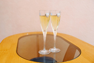 two glasses with champagne standing on the table