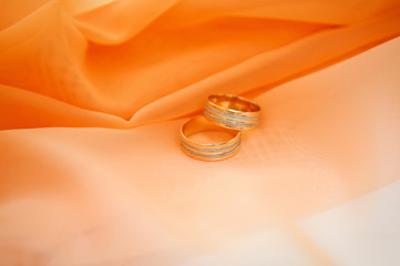 wedding rings on orange background