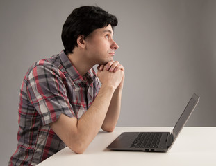 thinking man with laptop