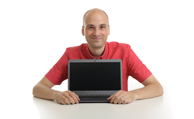 smiling bald man presenting something on laptop