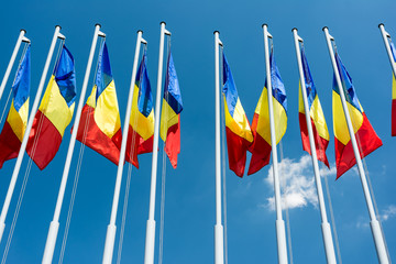 Romanian Flag Poles On Blue Sky
