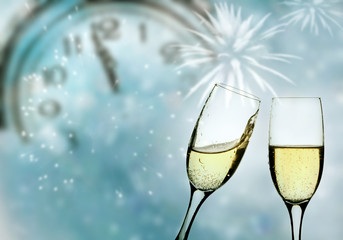 Glasses with champagne and clock close to midnight