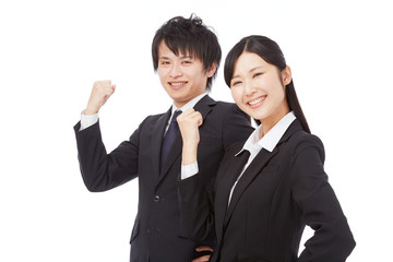 ガッツポーズするビジネスウーマンとビジネスマン