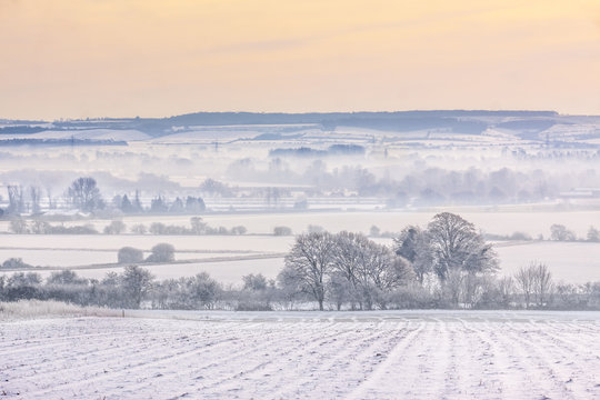 Fototapeta Winter mist over snow-covered fields