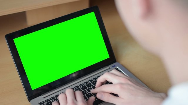 man works on computer (notebook - laptop)green screen - office