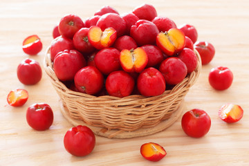 Red acerola - malpighia glabra, tropical fruit  in bowl on table