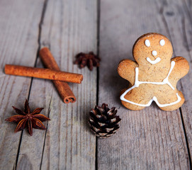 Christmas homemade gingerbread man on wooden background. Cinnamo