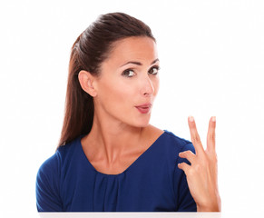 Lovely young woman making a victory sign