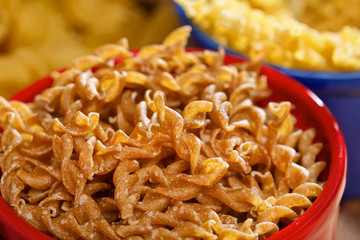 Variety of uncooked italian pasta on wooden table