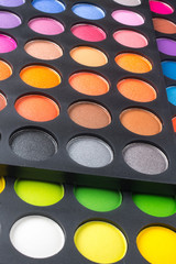 Palette of colorful eye shadows isolated on white background