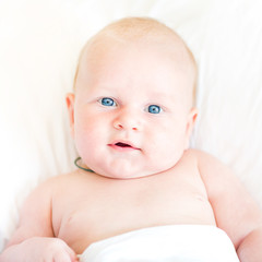 Peaceful newborn baby lying on a bed