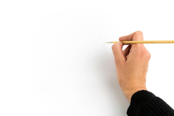 Hand holding brush, isolated on white background