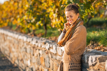 Portrait of happy young woman in autumn park