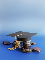 grad cap and coins