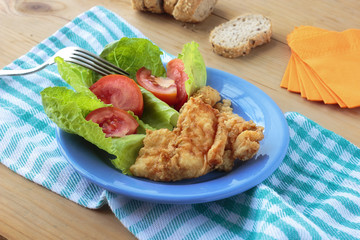 fried cod fish with fresh salad