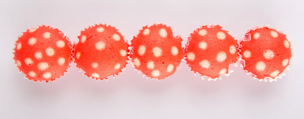 Red colored steamed rice polka dot muffin or apam polka dot
