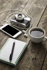 Vintage camera, diary with pan and cup pf coffee