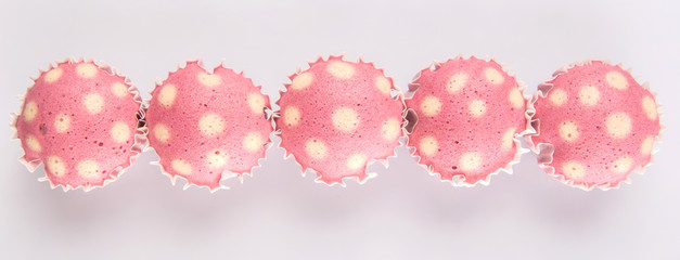 Pink colored steamed rice polka dot muffin or apam polka dot