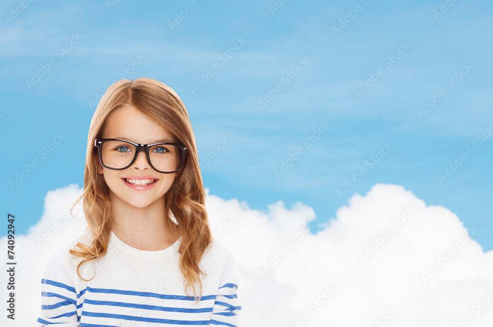 Wall mural smiling cute little girl with black eyeglasses