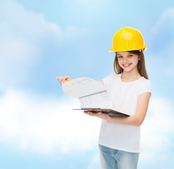 smiling little girl in hardhat with clipboard