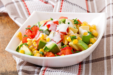 Mixed salad with avocado, tomatoes and sweet corn