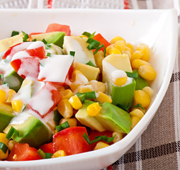 Mixed salad with avocado, tomatoes and sweet corn