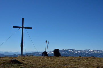 Summit cross next to backpacks