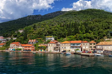 Fototapeta na wymiar View of Boka Kotorska with pier in Lepetance, Montenegro.